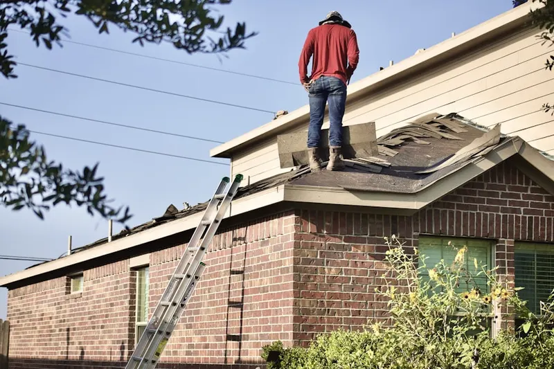 Professional roofer working on a residential roof in Jacobs Prairie